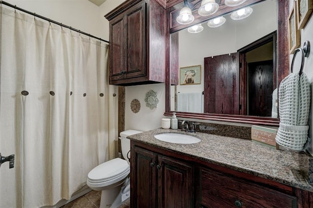 bathroom with vanity, tile patterned floors, and toilet