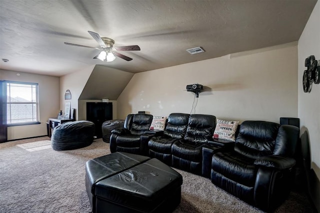 home theater room featuring ceiling fan, carpet flooring, and a textured ceiling