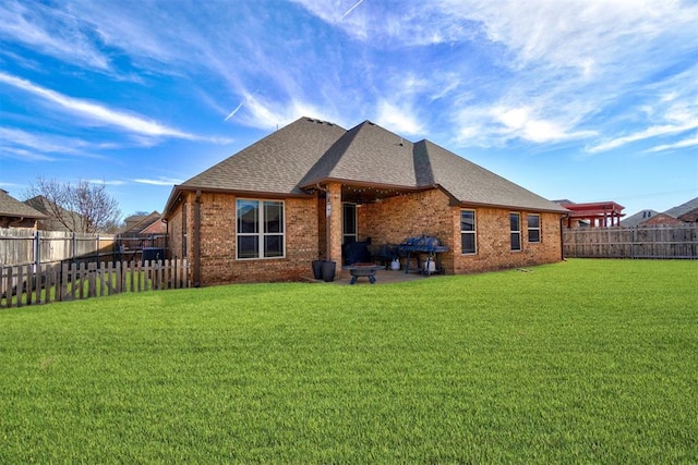 rear view of house featuring a yard and a patio area