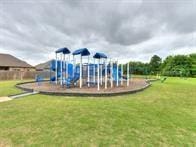 view of jungle gym featuring a lawn