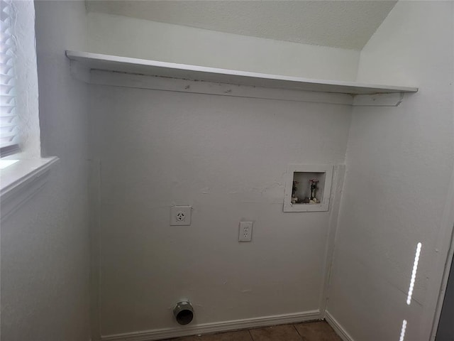 laundry area featuring dark tile patterned floors, hookup for a washing machine, and electric dryer hookup