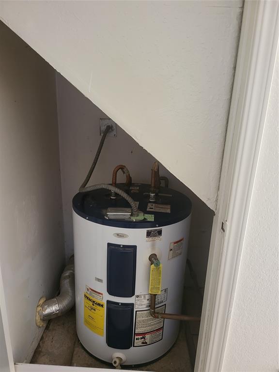 utility room featuring water heater