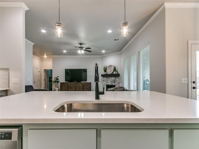 kitchen with pendant lighting, sink, a kitchen island with sink, and stainless steel dishwasher