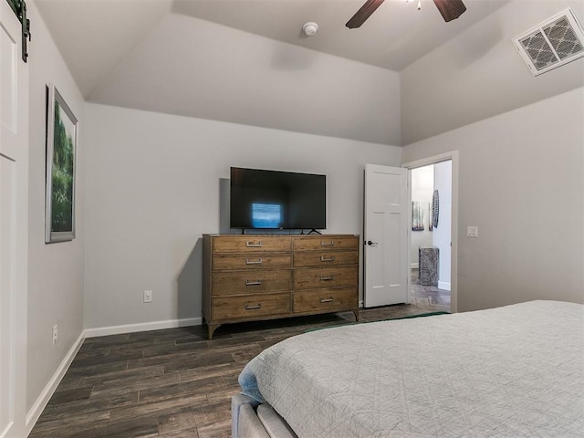 bedroom featuring a barn door, ceiling fan, lofted ceiling, and dark hardwood / wood-style flooring