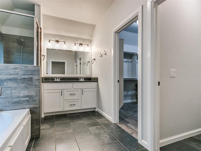 bathroom with vanity, tile patterned flooring, and a tub