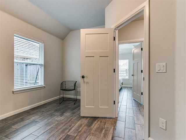 hall featuring dark hardwood / wood-style flooring and vaulted ceiling