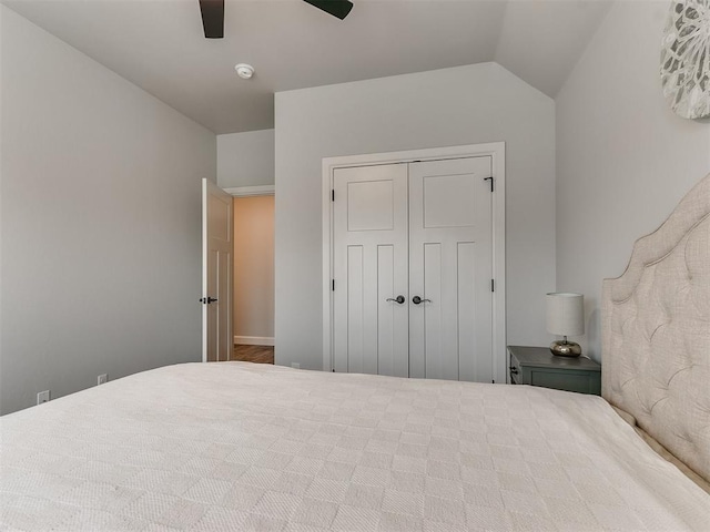 unfurnished bedroom featuring vaulted ceiling, ceiling fan, and a closet