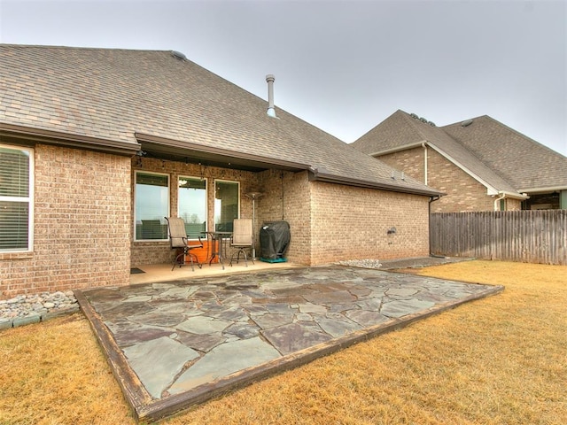 back of house featuring a patio and a lawn