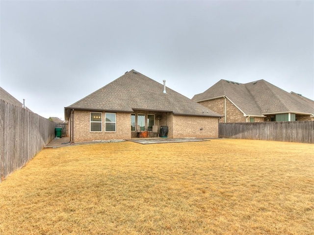 rear view of house with a yard