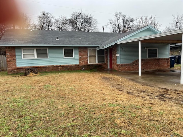 single story home with a carport and a front lawn