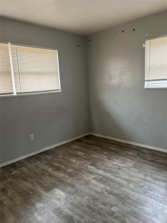 unfurnished room featuring dark hardwood / wood-style flooring