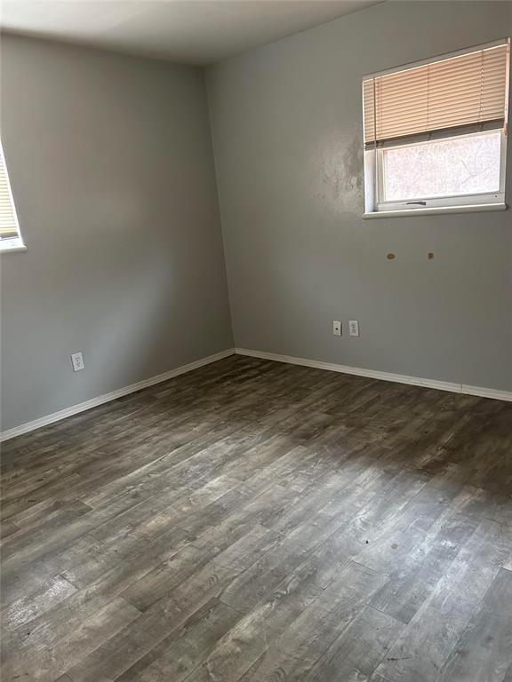 empty room featuring dark hardwood / wood-style flooring