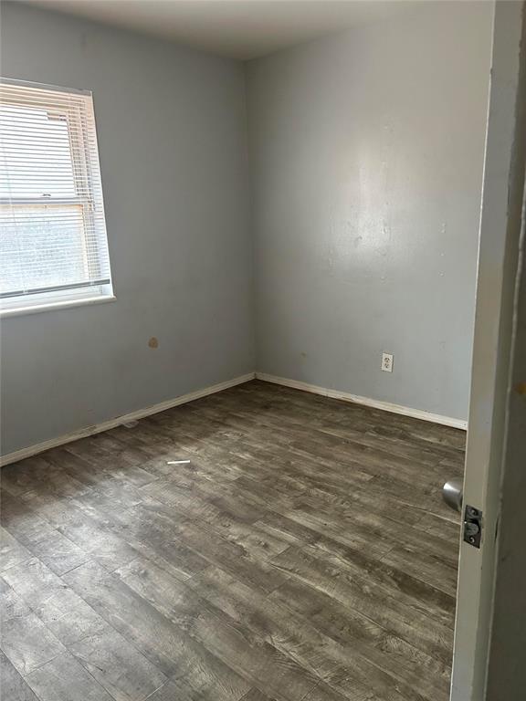 spare room featuring dark wood-type flooring