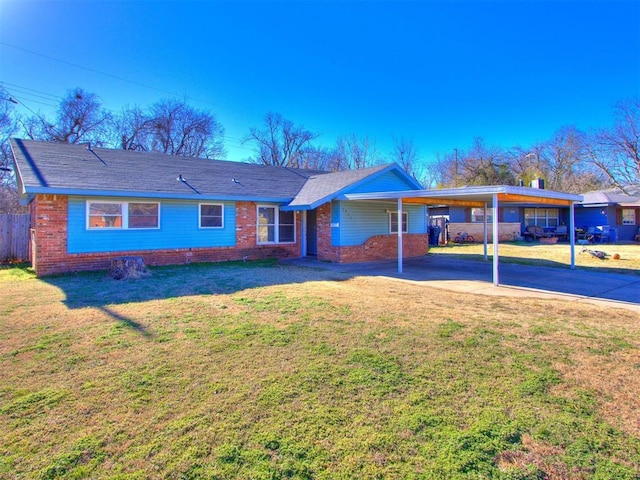 ranch-style home featuring concrete driveway, an attached carport, fence, a front lawn, and brick siding