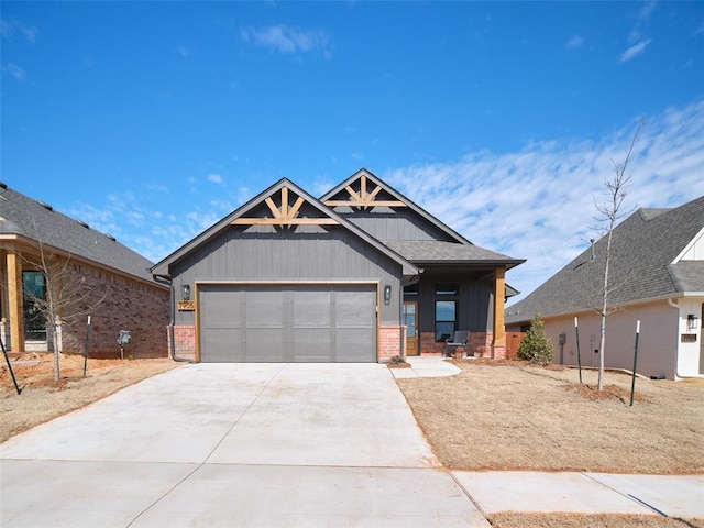 craftsman house featuring driveway, an attached garage, and brick siding