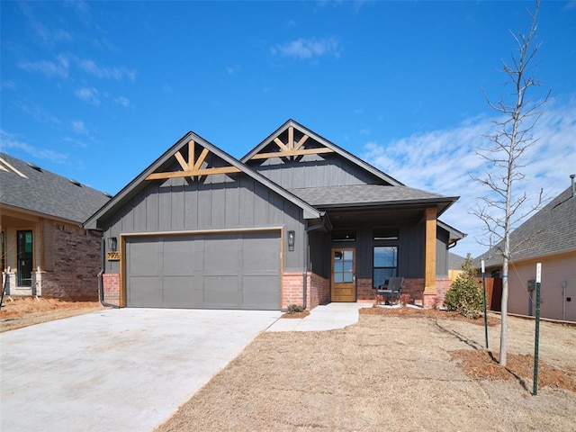 view of front of house with a garage, concrete driveway, brick siding, and a shingled roof