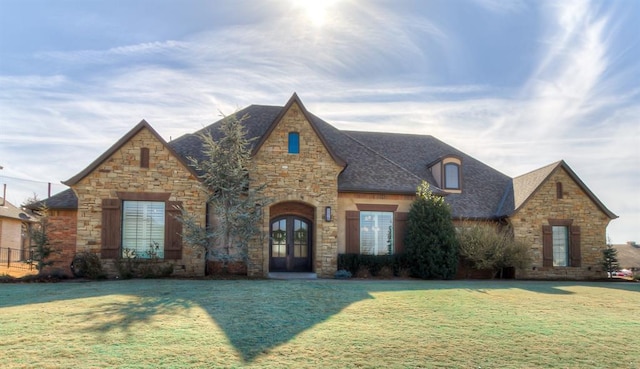 view of front of property with french doors and a front lawn