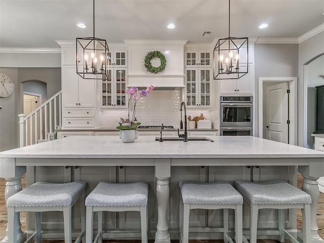 kitchen featuring a large island, pendant lighting, and a kitchen breakfast bar