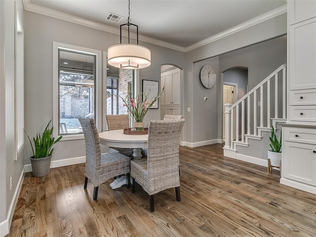 dining room featuring ornamental molding and hardwood / wood-style floors