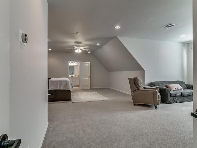 carpeted bedroom with vaulted ceiling, connected bathroom, and ceiling fan