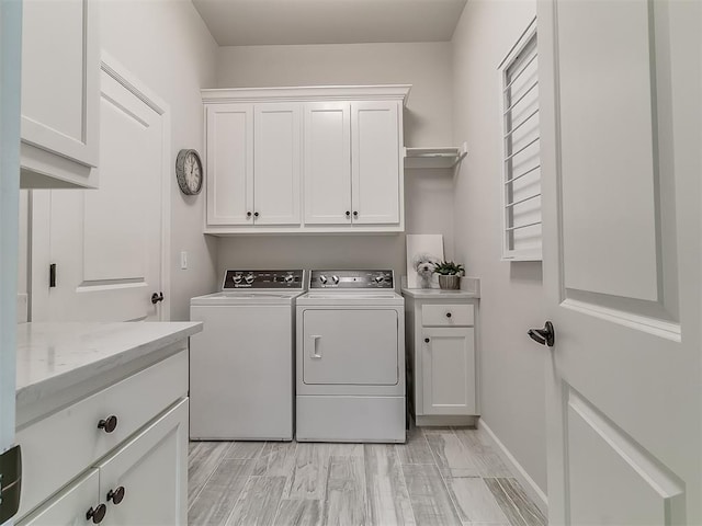 washroom featuring cabinets and washing machine and clothes dryer