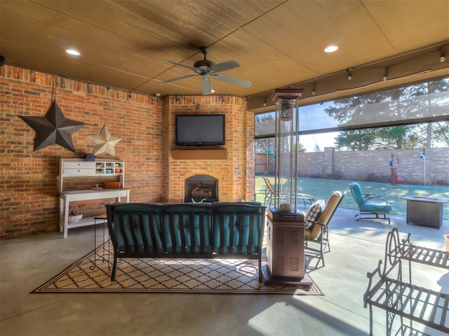 view of patio featuring ceiling fan and an outdoor living space with a fireplace