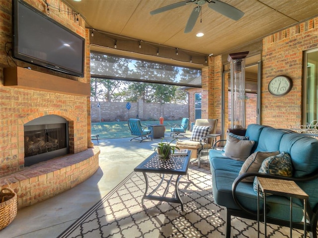 interior space featuring an outdoor living space with a fireplace and ceiling fan