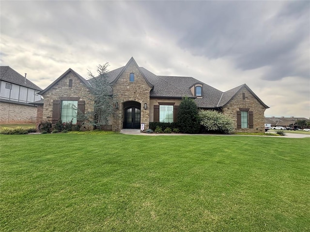 french country home with a front lawn