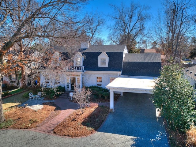 view of front of home featuring a carport and a balcony