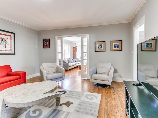 living room featuring hardwood / wood-style flooring and ornamental molding