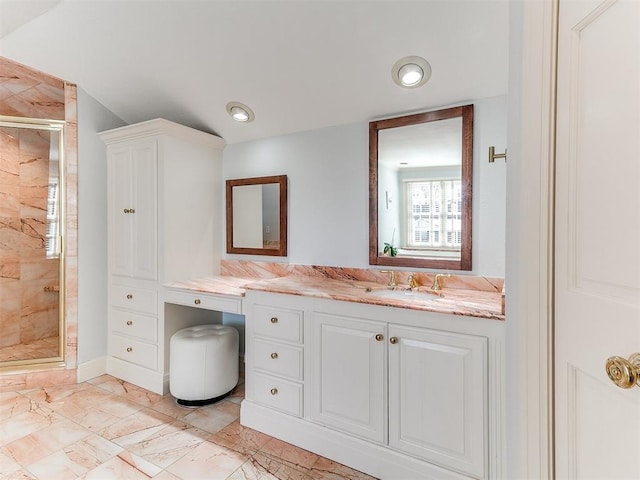 bathroom with vanity and a shower with door