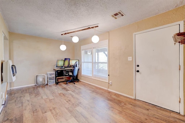 office area with hardwood / wood-style flooring and a textured ceiling