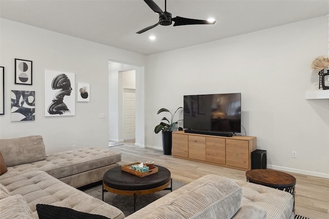 living room featuring ceiling fan and light wood-type flooring