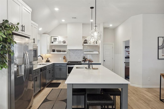 kitchen featuring gray cabinets, pendant lighting, white cabinetry, custom exhaust hood, and stainless steel appliances