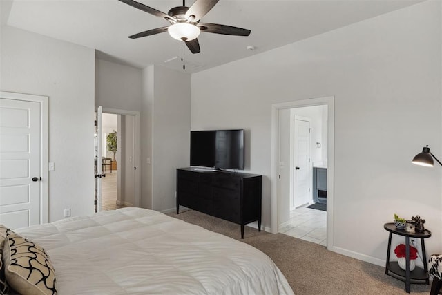 bedroom with light carpet, connected bathroom, and ceiling fan