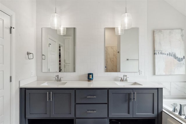 bathroom featuring vanity, backsplash, a tub, and tile walls