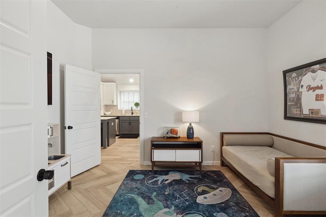 bedroom with light parquet flooring and sink