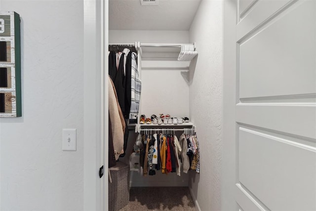 walk in closet with carpet flooring