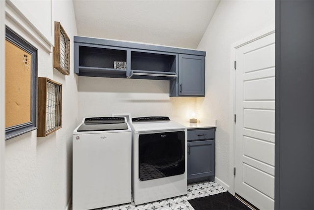 washroom with cabinets and washer and clothes dryer