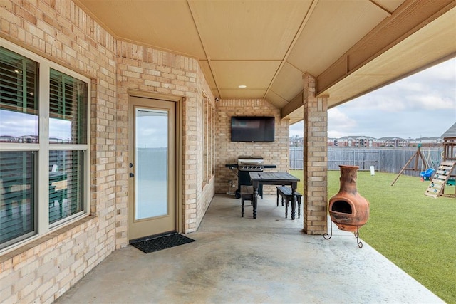 view of patio featuring a grill and a playground