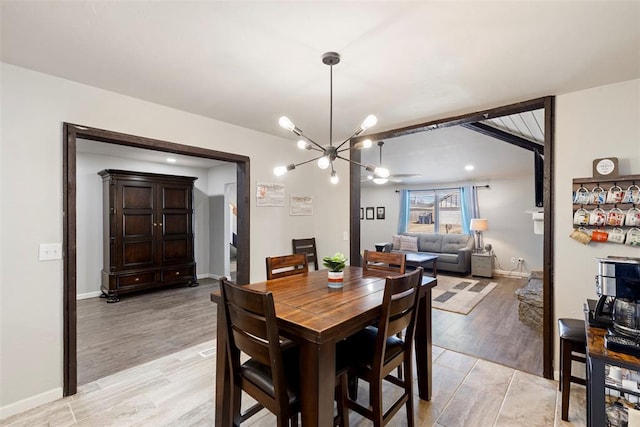 dining space featuring an inviting chandelier and light hardwood / wood-style flooring