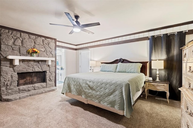 bedroom featuring ceiling fan, ornamental molding, a fireplace, and carpet floors