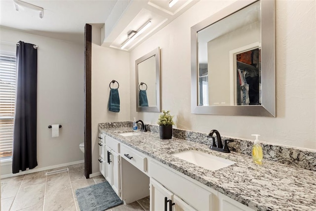 bathroom with vanity, toilet, and tile patterned flooring