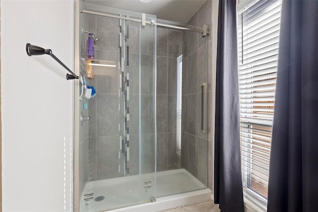 bathroom featuring a healthy amount of sunlight and an enclosed shower