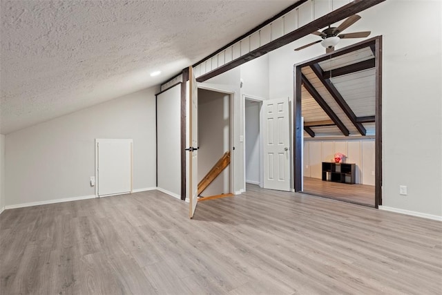 bonus room with vaulted ceiling, ceiling fan, a textured ceiling, and light hardwood / wood-style floors