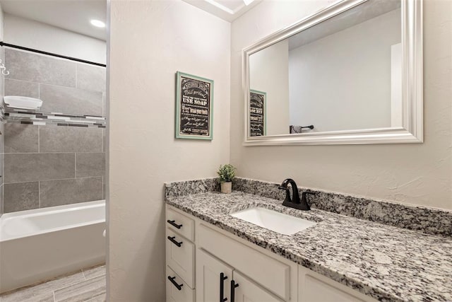 bathroom with vanity and tiled shower / bath