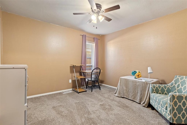 home office with ceiling fan and carpet