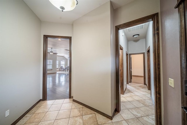 corridor with light tile patterned flooring