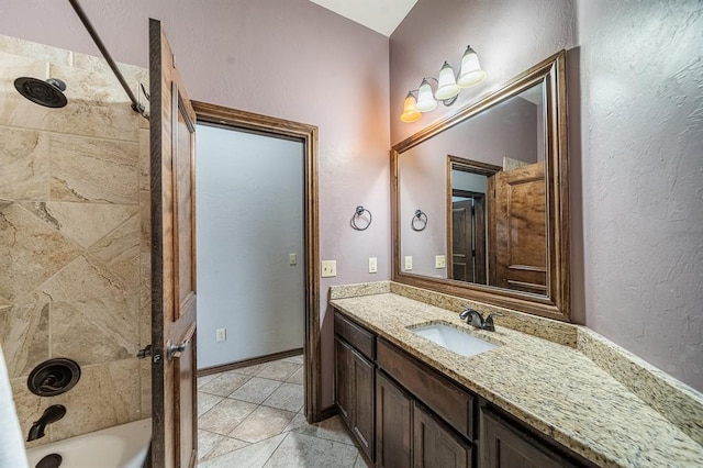 bathroom with vanity, tile patterned floors, and tiled shower / bath