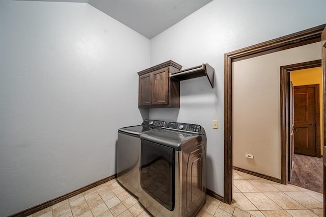 washroom featuring washing machine and dryer and cabinets